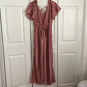 Mauve striped jumpsuit with flared/boot cut style.